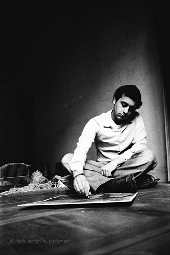 Chico pintando sentado en el suelo.