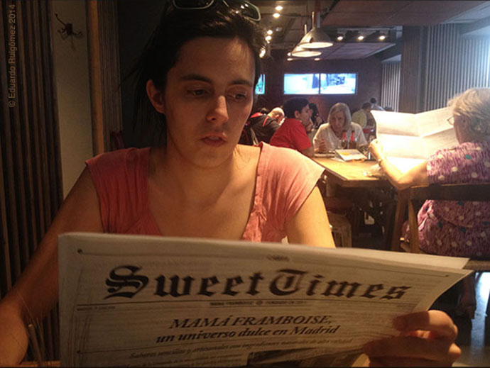 Una chica leyendo el periódico en una cafetería